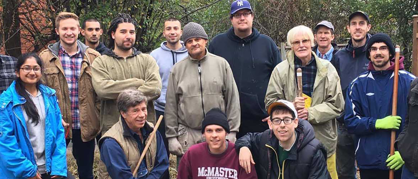 A group photo of volunteers standing in a backyard.